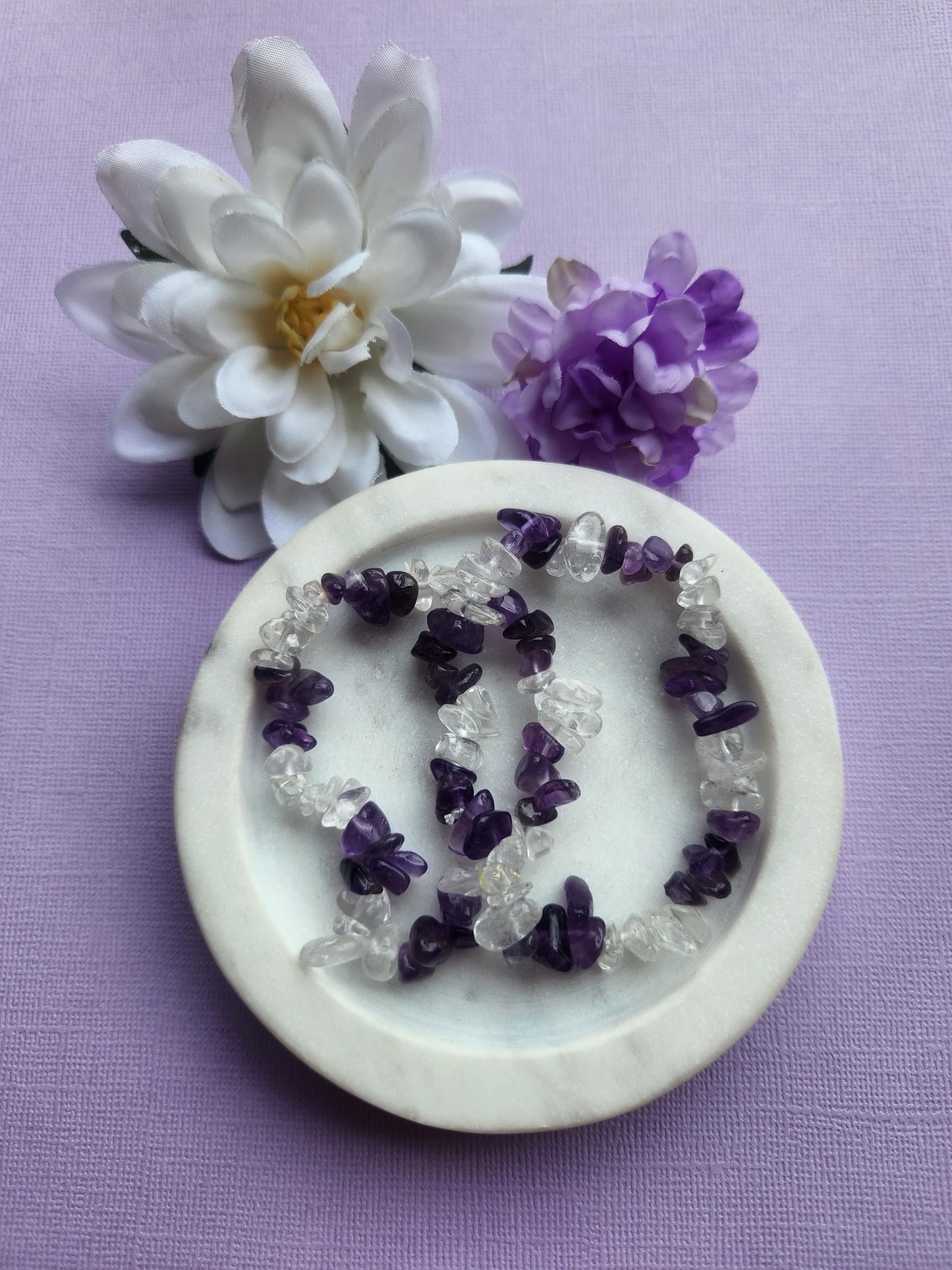 Amethyst and Clear Quartz chip bracelet featuring natural purple amethyst and clear quartz crystal chips on one stretchy bracelet, handmade mixed crystal chip bracelet, calming and clarity crystal jewelry, crown chakra and energy amplification bracelet, spiritual healing gemstone bracelet, boho crystal bracelet for meditation gifting photographed close up