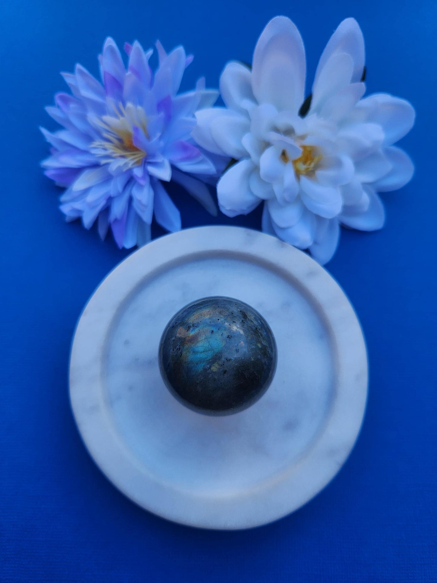 Labradorite crystal sphere polished natural labradorite gemstone ball with blue and gold labradorescence flash, intuitive protection crystal, third eye chakra healing stone, spiritual awakening and transformation gemstone sphere, polished labradorite sphere for meditation decor and energy work photographed close up