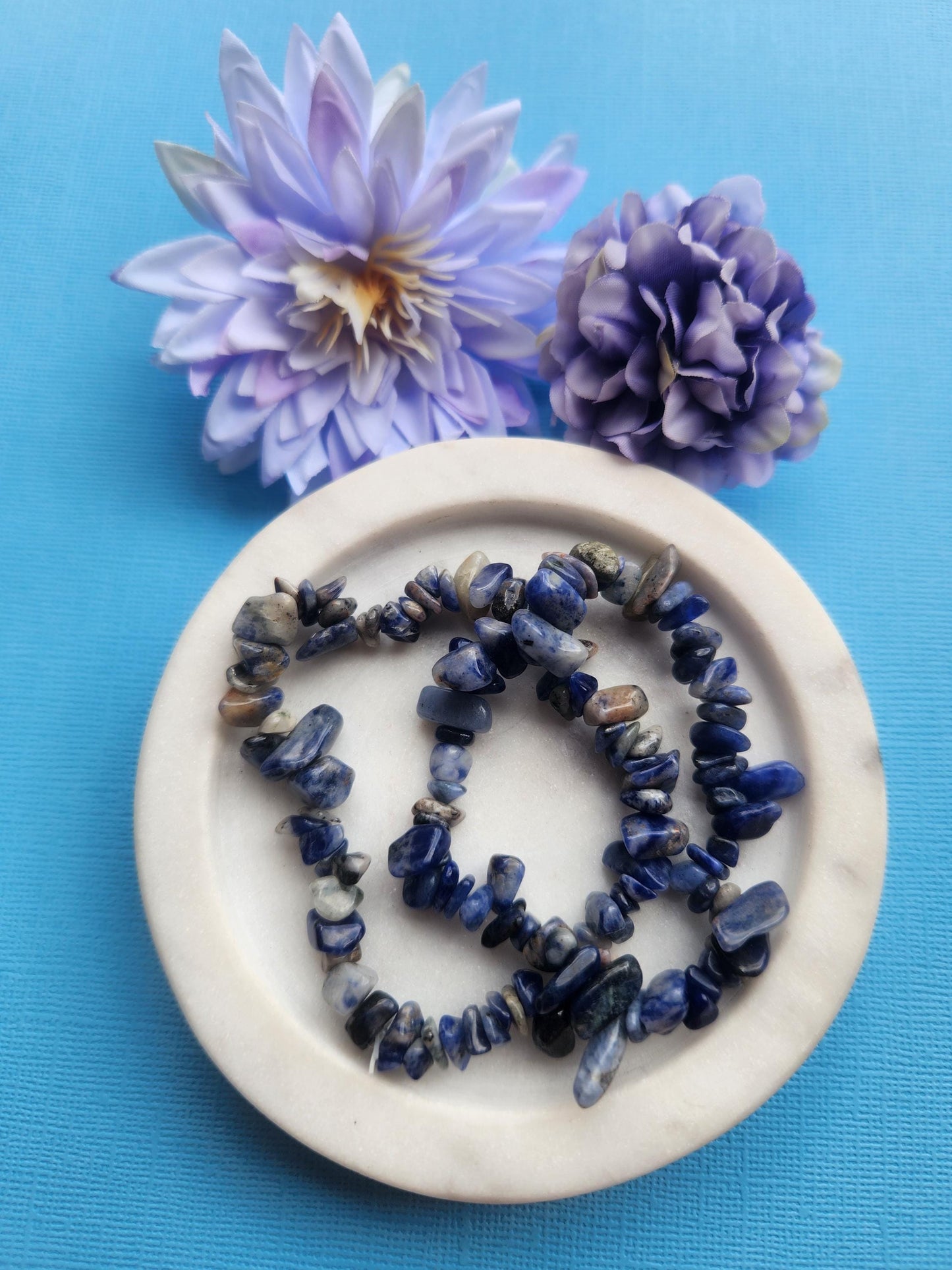 Sodalite chip bracelet featuring natural blue sodalite crystal chips with white marbling, polished gemstone chip bracelet on stretch cord, handcrafted sodalite crystal bracelet for clarity, intuition and communication, blue crystal chip bracelet for stress relief and emotional balance, metaphysical sodalite bracelet, crystal healing jewelry, sodalite gemstone bracelet for everyday wear, spiritual crystal bracelet gift, unisex sodalite bracelet, handmade crystal jewelry