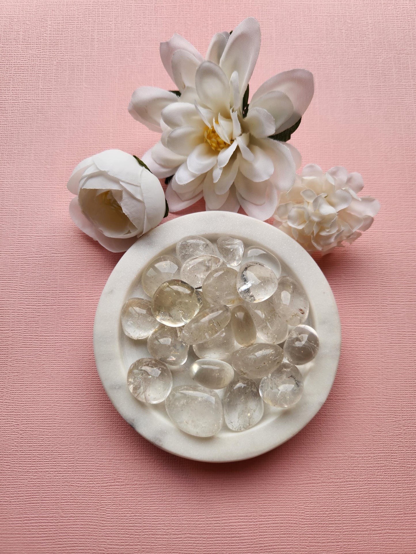 Natural Clear Quartz tumbled stones displayed, showcasing their smooth, polished surfaces and transparent clarity. These versatile crystal tumbled stones are widely used for healing, energy amplification, meditation, and chakra balancing. Perfect for spiritual tools, crystal collections, and jewelry making. Their clear, glossy appearance reflects purity and natural beauty, making them a must-have in any crystal enthusiast’s collection.
