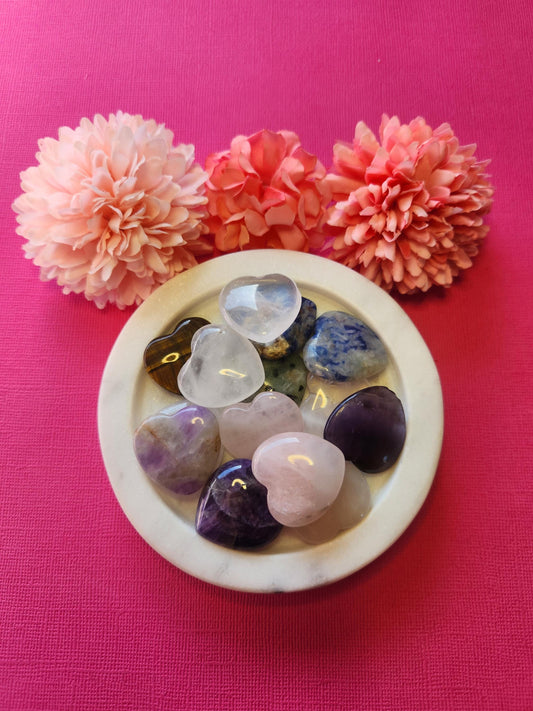 Small mystery crystal hearts displayed on a pink background, featuring a variety of polished mini gemstone hearts like rose quartz, amethyst, clear quartz, and more. Each small heart is intuitively chosen to bring unique healing properties such as love, protection, clarity, and energy balance. Perfect as a surprise gift, pocket stone, or witchy decor. Ideal for crystal collectors, meditation, and spiritual healing.