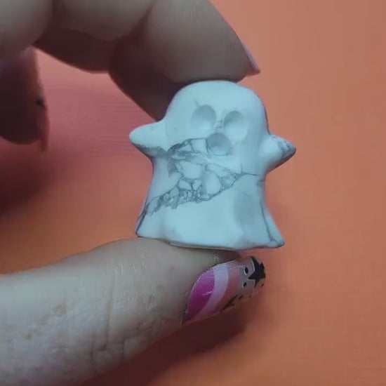 Close-up of a white Howlite ghost crystal held in hand, featuring natural grey veining. Perfect for Halloween décor, witchy altars, spiritual healing, meditation, and calming energy. Ideal for crystal collectors, spooky-season gifts, and mystical home décor.