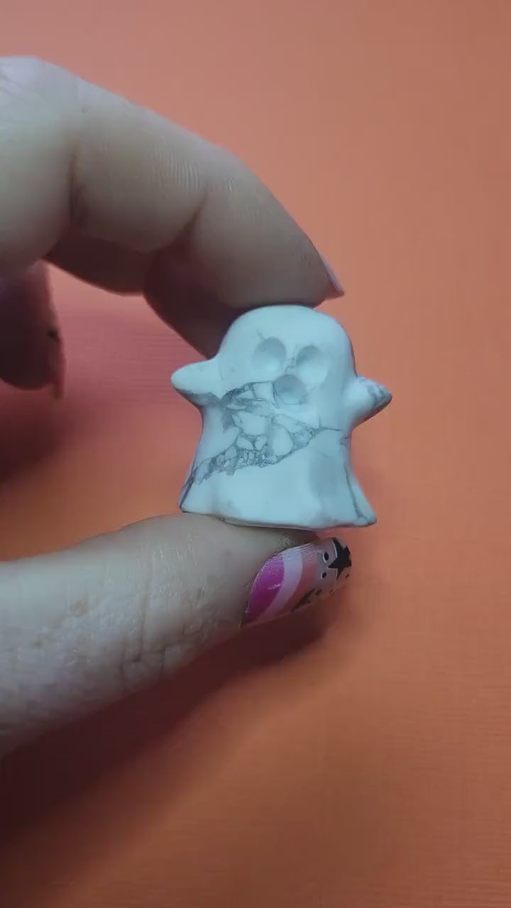 Close-up of a white Howlite ghost crystal held in hand, featuring natural grey veining. Perfect for Halloween décor, witchy altars, spiritual healing, meditation, and calming energy. Ideal for crystal collectors, spooky-season gifts, and mystical home décor.