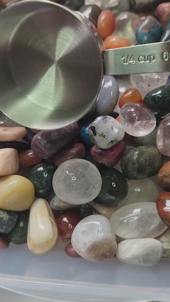 Close-up video of a 1/4 cup sample scoop of crystal tumbles only confetti being poured or held, featuring a minimum of 10 polished gemstone tumbles per scoop. Mixed colorful crystals displayed for spiritual healing, meditation, intention setting, chakra balancing, altar décor, crystal crafting, DIY resin art, metaphysical collections, and high-quality Etsy product listing SEO. Perfect for crystal lovers, collectors, and mystical home décor enthusiasts