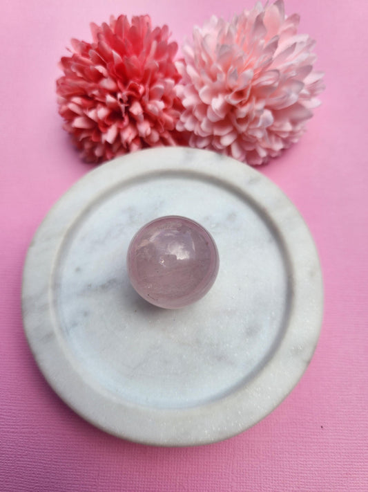 Rose Quartz crystal sphere polished natural soft pink rose quartz gemstone ball, love and self love crystal, heart chakra healing stone, emotional healing and compassion gemstone sphere for meditation decor and energy work, polished rose quartz sphere photographed close up with smooth glossy finish