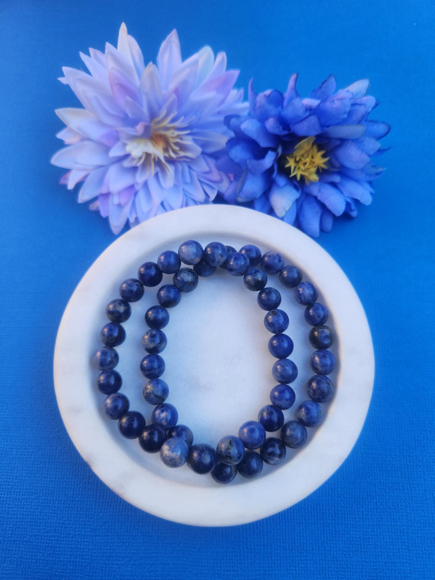 Sodalite 8mm beaded bracelet handmade with natural blue and white Sodalite gemstone beads, stretchy crystal bracelet for communication intuition mental clarity and self expression, genuine Sodalite crystal jewellery ideal for throat chakra work meditation mindfulness and everyday wear, polished round gemstone beads with rich royal blue colouring and natural white veining, healing crystal bracelet for confidence focus emotional balance and spiritual growth, gift for crystal lovers Australia shop.