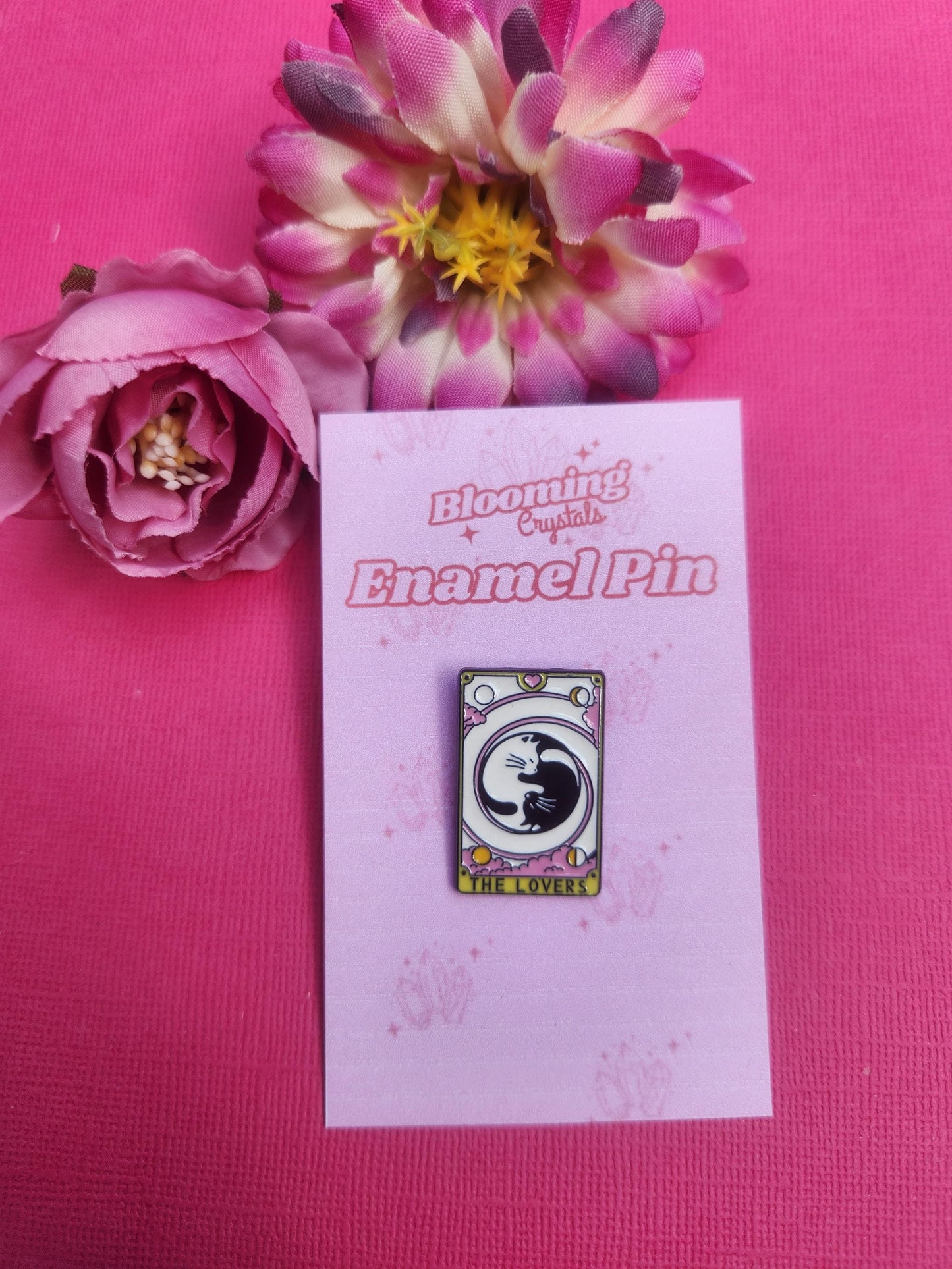 The Lovers tarot enamel pin featuring two cats, one black and one white, hugging in the centre, romantic celestial design inspired by tarot card symbolism, witchy aesthetic enamel pin for love, connection and harmony, cute cat lovers badge for bags jackets and pin collections, glossy durable lapel pin