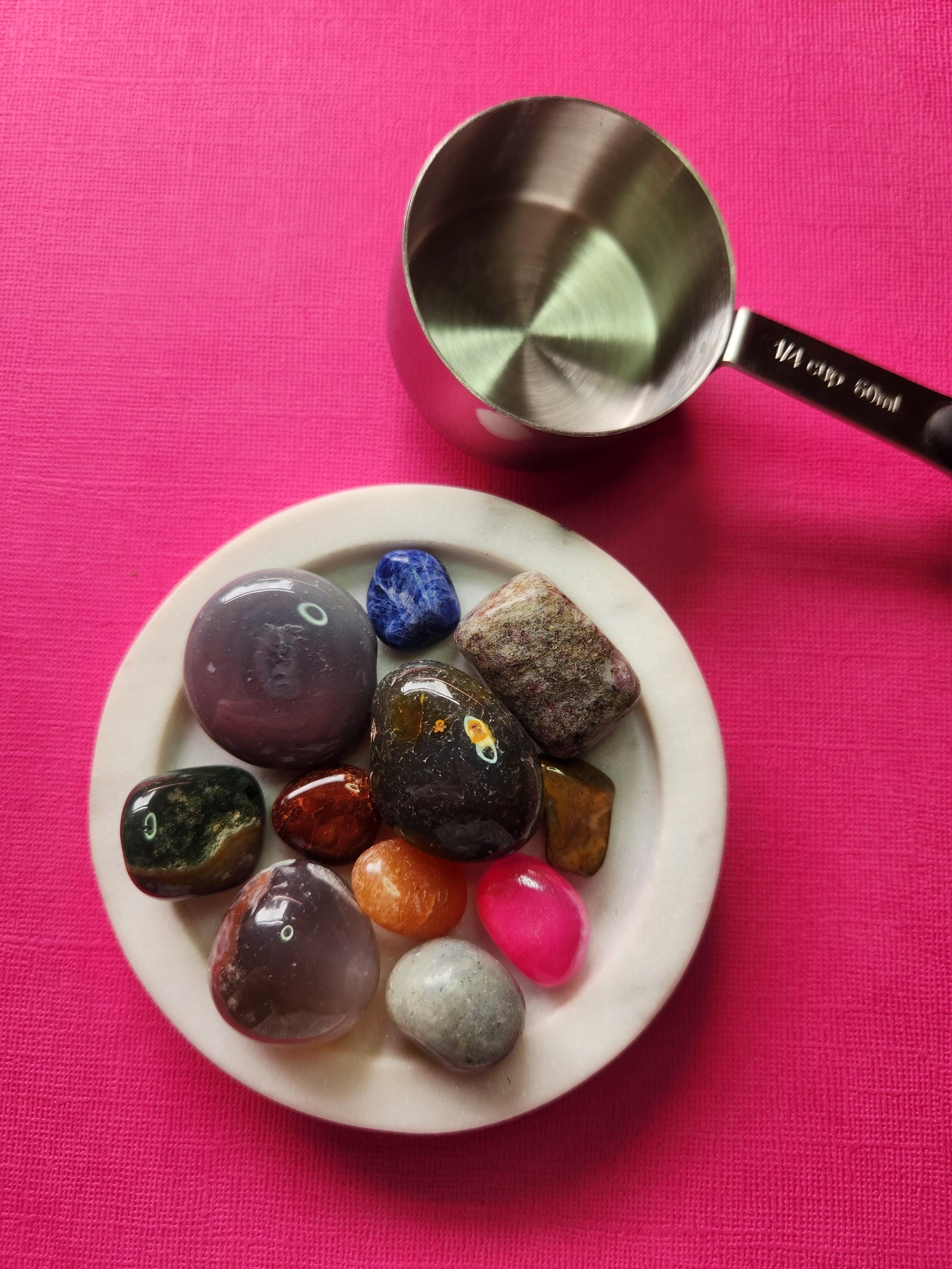 High-resolution image of our 1/4 cup crystal confetti scoop in a white dish with a soft pink background, featuring at least 10 mixed gemstone tumbles in every scoop. Vibrant polished crystals perfect for healing work, altar decor, resin artists, mystery scoop lovers, and gem collectors. SEO-optimised alt text for Etsy and online crystal shops.