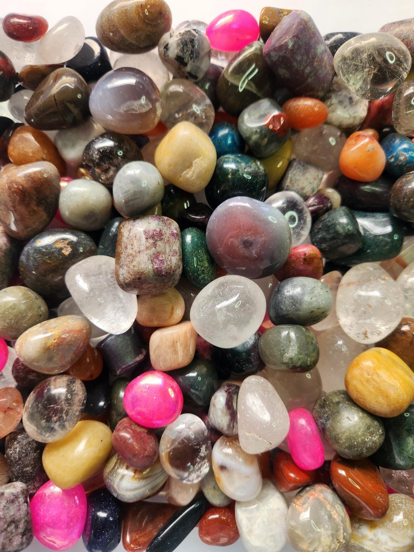 Macro close-up photo of assorted polished crystal tumbles filling the entire frame, showcasing mixed gemstones with rich colours and smooth finishes. Ideal SEO alt text for crystal confetti, gemstone mixes, metaphysical supplies, altar decor inspiration, and high-quality crystal shop product imagery